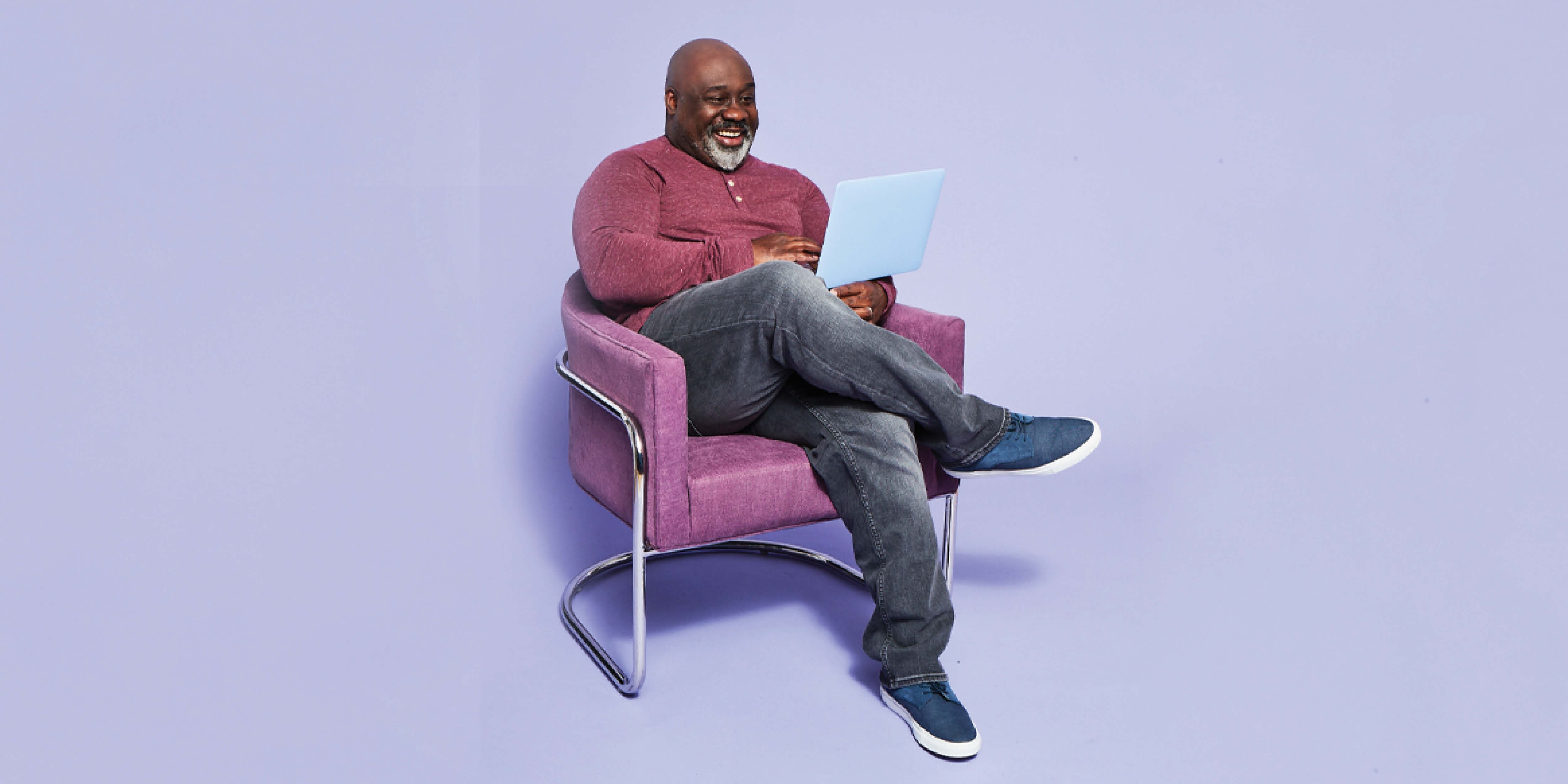 man smiling at laptop